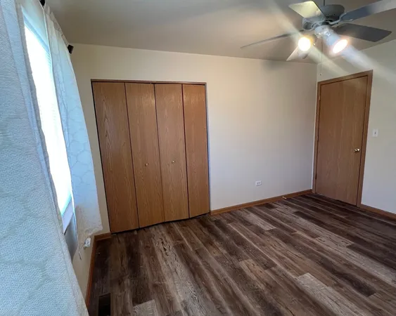 a view of a room with wooden floor and fan