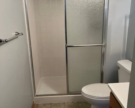 a white toilet sitting next to a bathroom sink