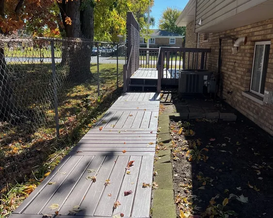 a view of a patio with table and chairs next to a yard