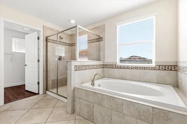 a spacious bathroom with a bathtub and a shower