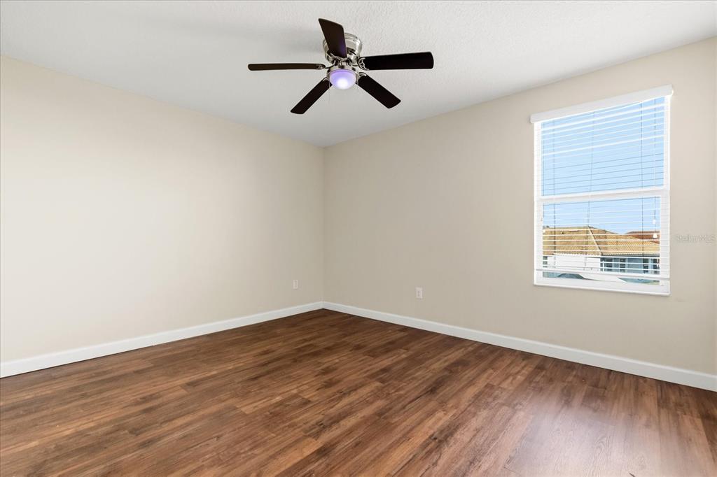 12036 Cardinal Flower Drive Riverview, FL 33579 - Photo 18 of 37 a view of empty room with wooden floor and fan
