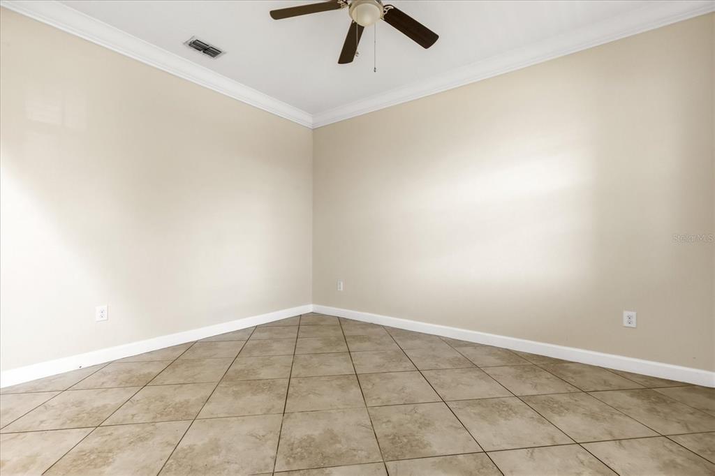 12036 Cardinal Flower Drive Riverview, FL 33579 - Photo 3 of 37 an empty room with a ceiling fan and carpet