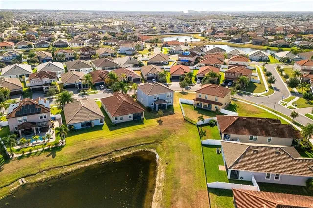 an aerial view of residential houses with outdoor space