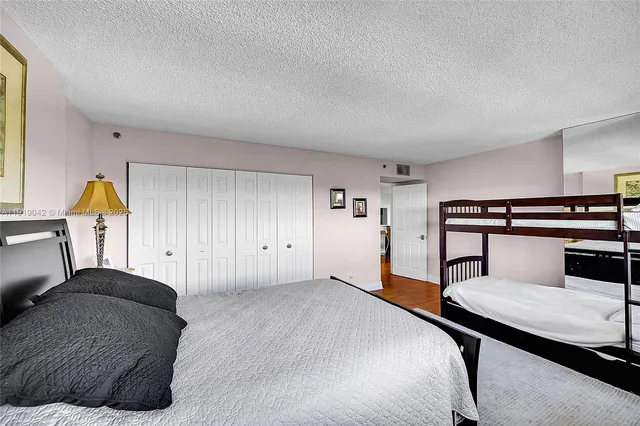 a dining room with wooden floor a glass table and chairs