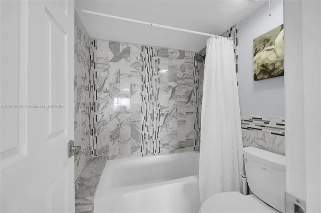 a bedroom with a bed and flat screen tv