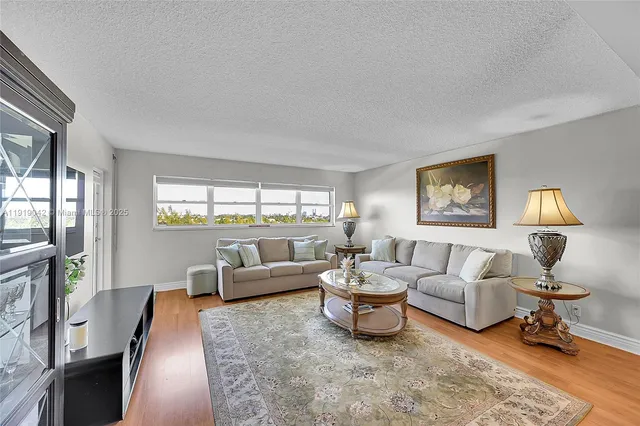a kitchen with a refrigerator sink and cabinets