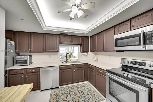 a view of a dining room with furniture a chandelier and wooden floor