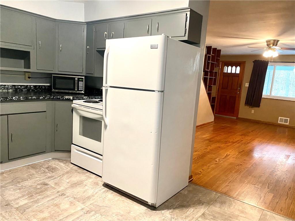 167 Fairfield Road Tarentum, PA 15084 - Photo 10 of 24 a white refrigerator freezer and a stove sitting inside of a kitchen