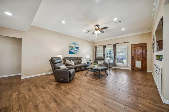 a living room with furniture and wooden floor