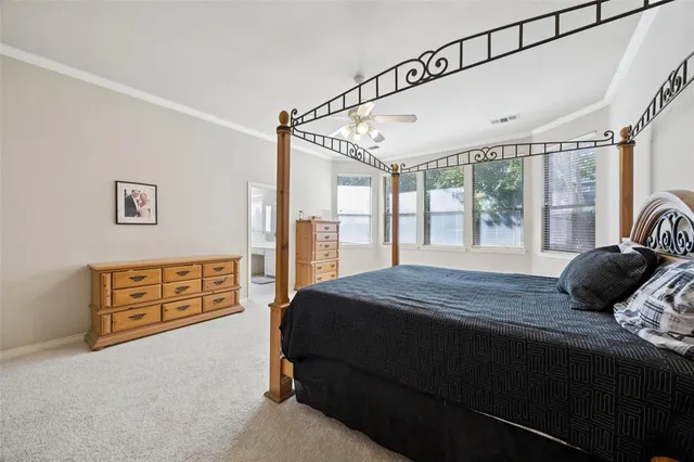 a bedroom with a bed next to a large window with the outer view