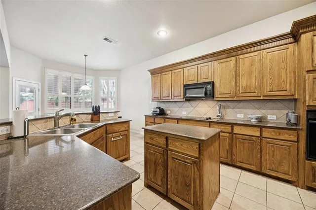 a kitchen with stainless steel appliances granite countertop a sink stove microwave and cabinets