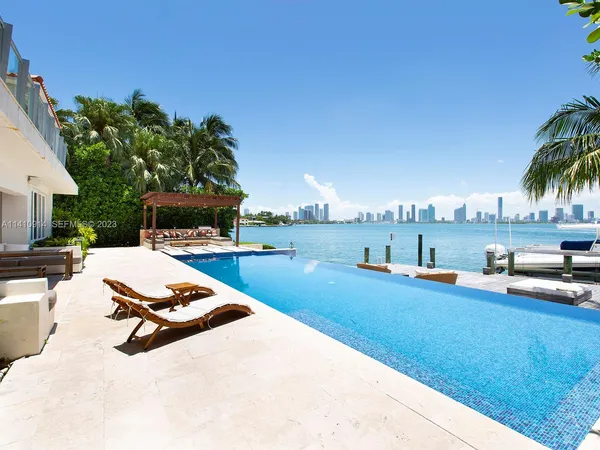 a view of a swimming pool with lounge chairs