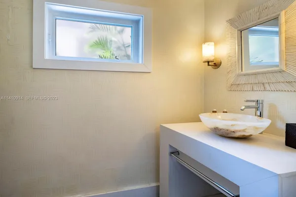 a bathroom with a sink and a window