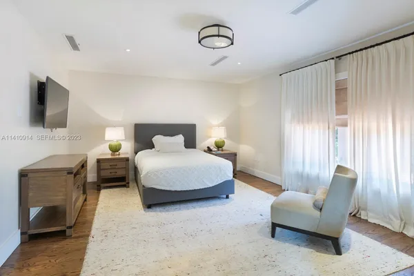 a bedroom with a bed and a couch