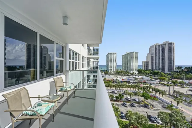 a view of a city from a chairs and table in a patio