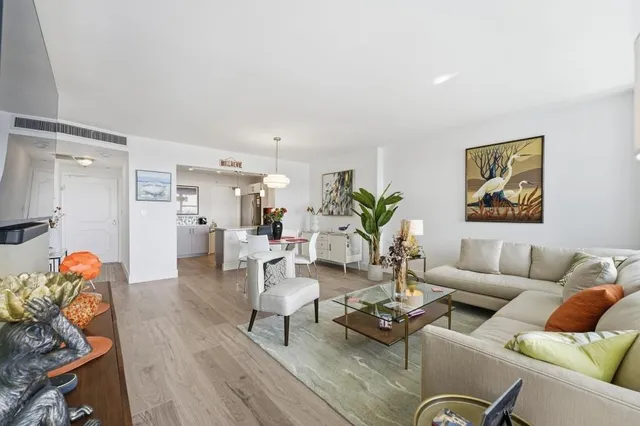 a living room with furniture a rug and a wall painting