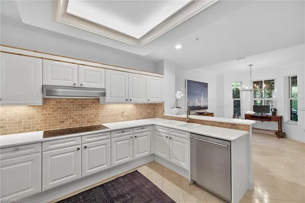 a kitchen with sink cabinets and chair