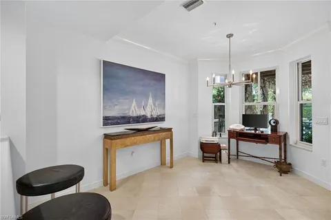 a living room with furniture a window and a chandelier