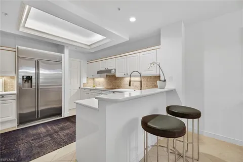 a kitchen with stainless steel appliances granite countertop a sink a stove and a refrigerator