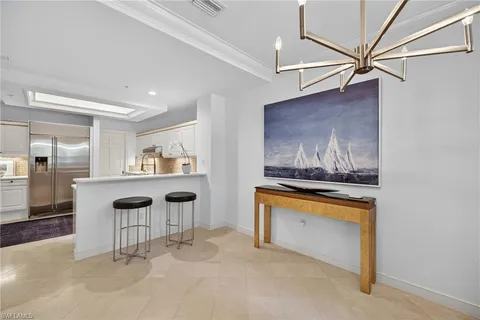 a view of cabinets with chair and front door