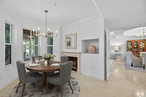 a view of a dining room with furniture and chandelier