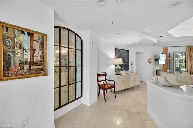 a living room with furniture and a painting on the wall