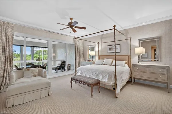 a spacious bedroom with a bed and a chandelier