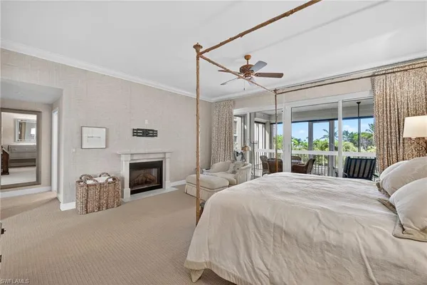 a spacious bedroom with a large bed and a fireplace