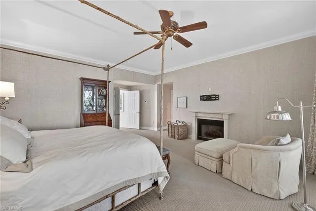 a spacious bedroom with a bed and a chandelier
