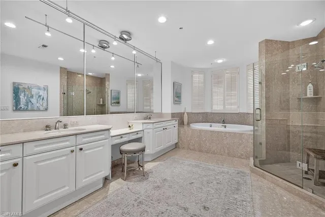 a large bathroom with a large mirror vanity and shower