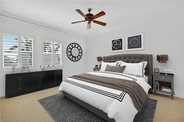 a bedroom with bed and a large window