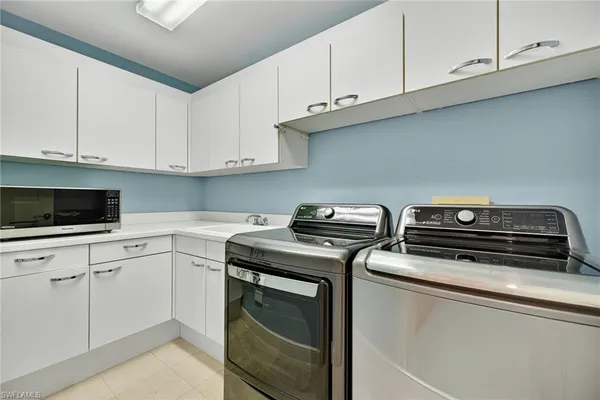 a kitchen with white cabinets and a stove top oven