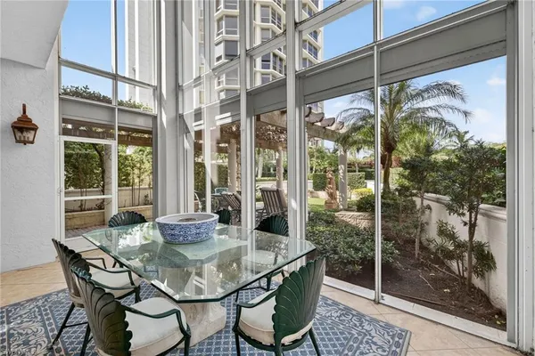 a dining room with furniture window and outside view