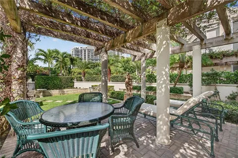 a view of a patio with a table chairs and a backyard