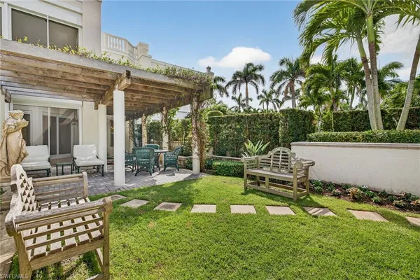a view of a house with backyard porch and sitting area