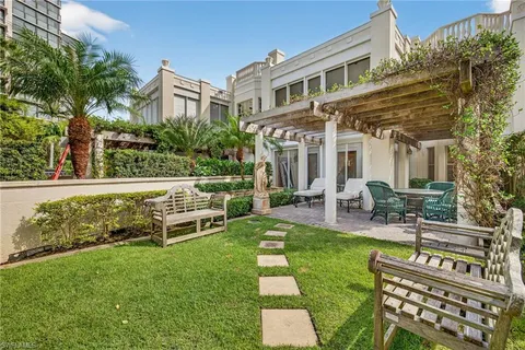 a view of a house with a yard patio and sitting area