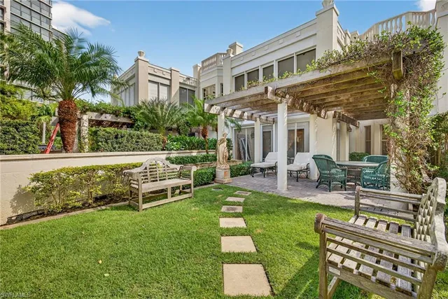 a view of a house with a yard patio and sitting area