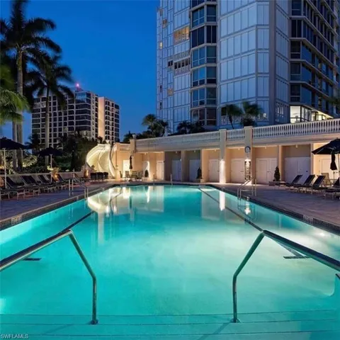 a swimming pool view with a outdoor seating