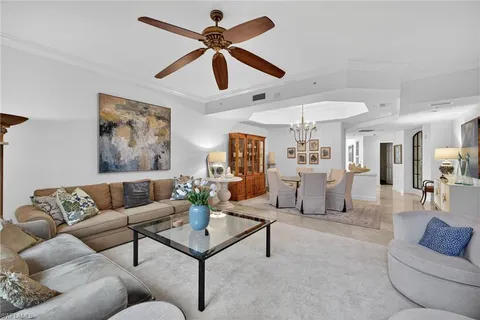 a living room with furniture and a ceiling fan