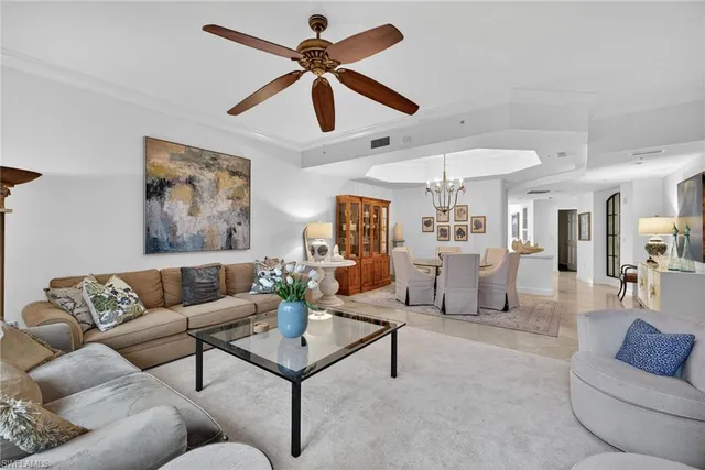 a living room with furniture and a ceiling fan