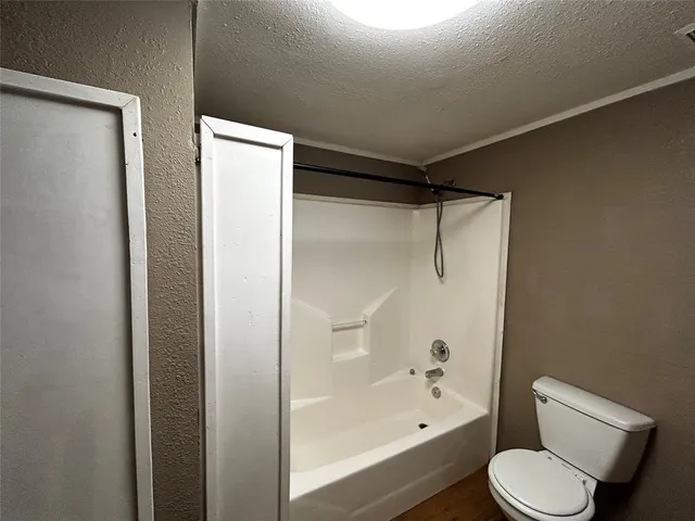 a bathroom with a shower and toilet