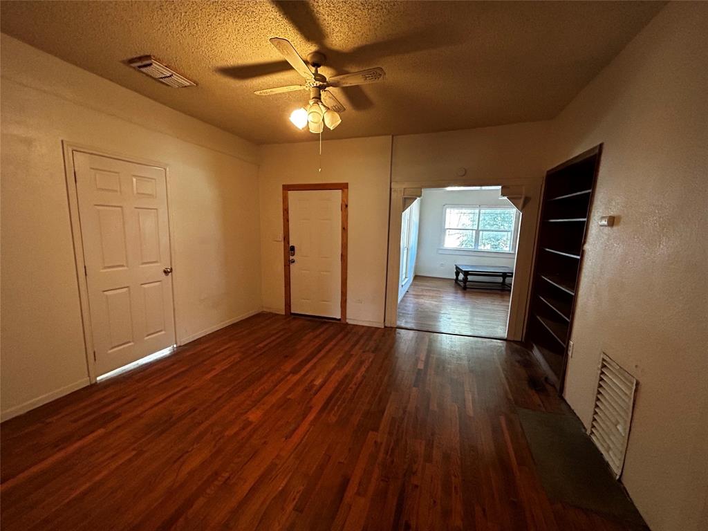 910 West Long Stephenville, TX 76401 - Photo 20 of 40 wooden floor in an empty room with a window