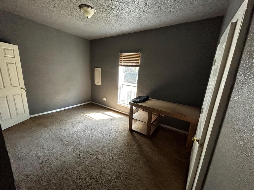 910 West Long Stephenville, TX 76401 - Photo 33 of 40 a view of an empty room with wooden floor and a window
