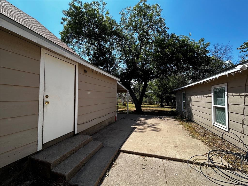 910 West Long Stephenville, TX 76401 - Photo 37 of 40 a view of backyard with wooden fence and large trees