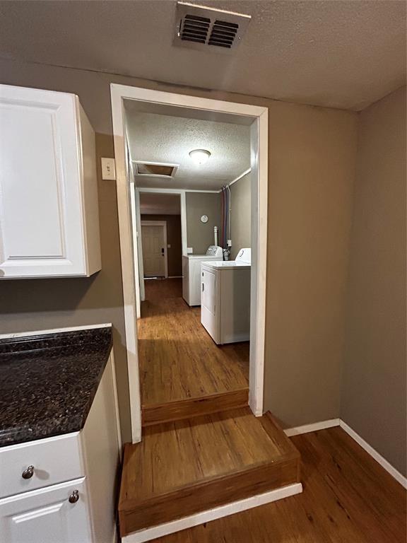 910 West Long Stephenville, TX 76401 - Photo 5 of 40 a view of kitchen and hallway with wooden floor