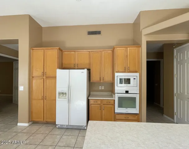 a kitchen with stainless steel appliances a refrigerator and a sink