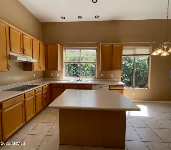 a kitchen with stainless steel appliances granite countertop a sink counter space and a large window