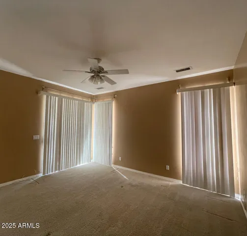 a view of a livingroom with a ceiling fan and window