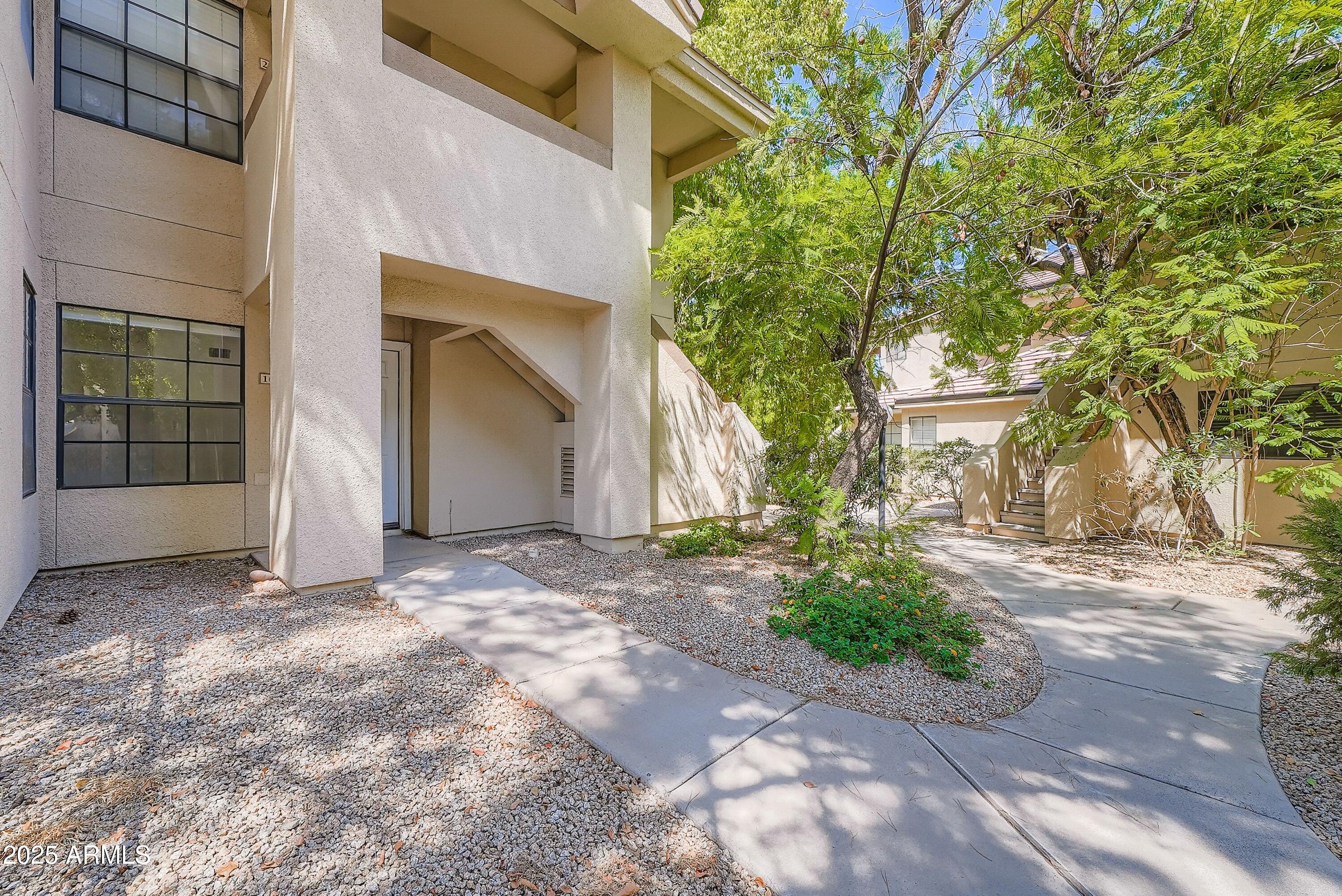 6885 East Cochise Road, Unit 105 Paradise Valley, AZ 85253 - Photo 1 of 11 a view of a house with a street