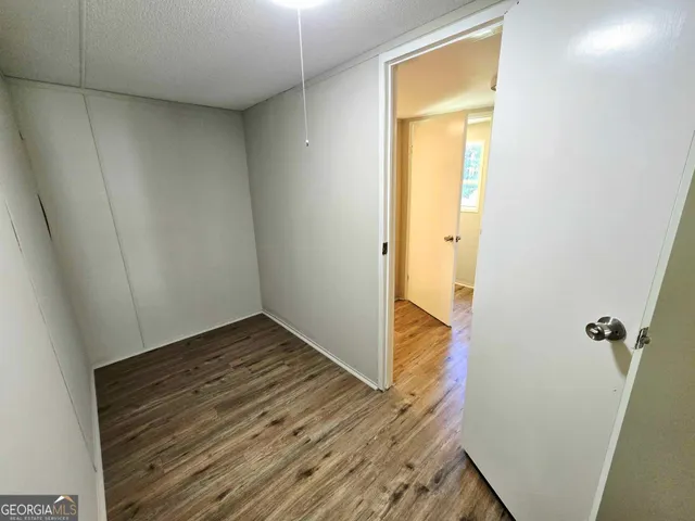 a view of a hallway with wooden floor